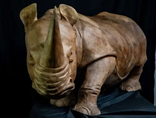 Product image of the product “Rhinocerus, carved from Suar wood. In the sizes from 120 to 150cm. ”